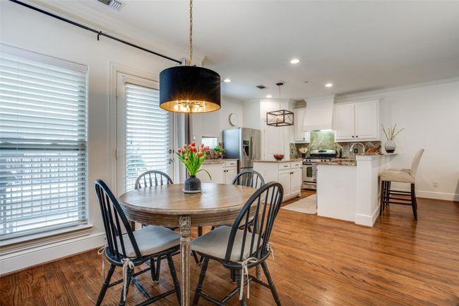 Dining area with light wood-style floors, recessed lighting, and crown molding | Image 4