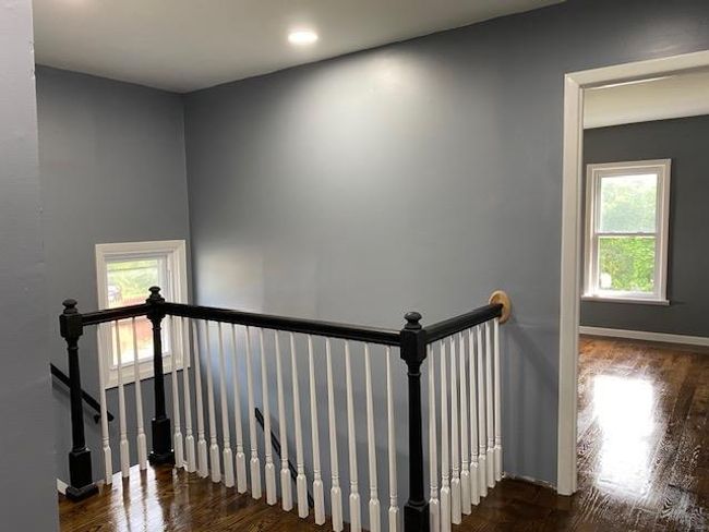 Staircase with wood finished floors and recessed lighting | Image 33