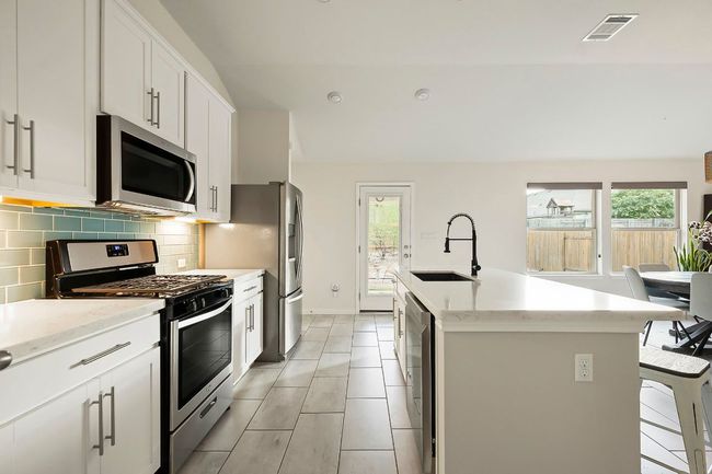 Stainless-steel appliances make meal prep a breeze for the home chef. | Image 9
