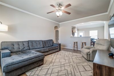 Living room featuring ornamental molding, light wood-type flooring, and ceiling fan | Image 3