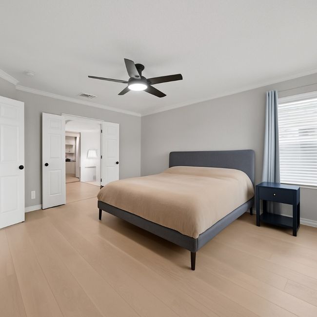 Primary bedroom with view of ensuite; large, light and airy, ceiling fan, and light wood finished floors | Image 14