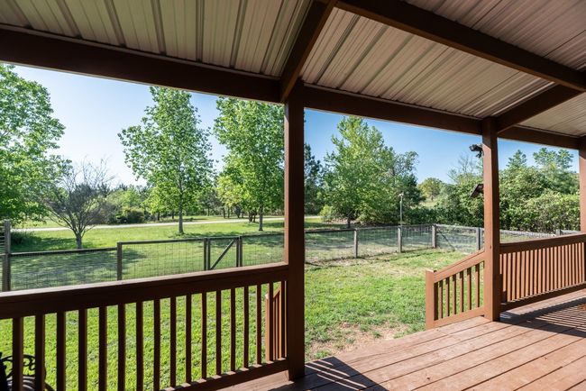 Wooden deck with a fenced backyard and a lawn | Image 31