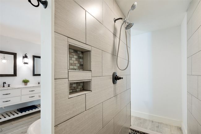 Large walk through shower provides privacy and built in storage | Image 22