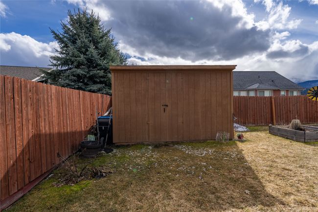 View of shed featuring a vegetable garden and a fenced backyard | Image 22