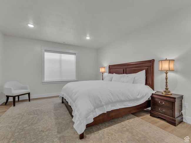 Bedroom featuring wood finished floors, baseboards, and recessed lighting | Image 37