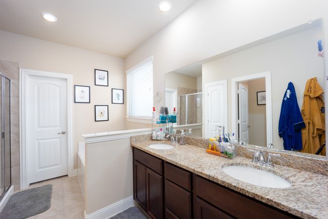 Full bathroom with a stall shower, double vanity, tile patterned flooring, and a garden tub | Image 14