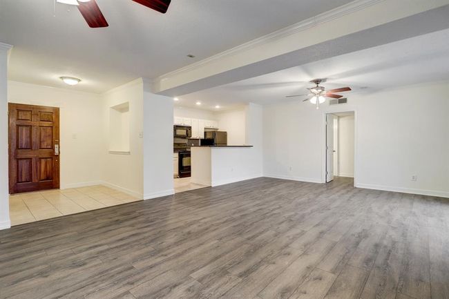 A nice foyer with art niche and you own laundry room. Wood floors in the foyer, living room, dining room | Image 7