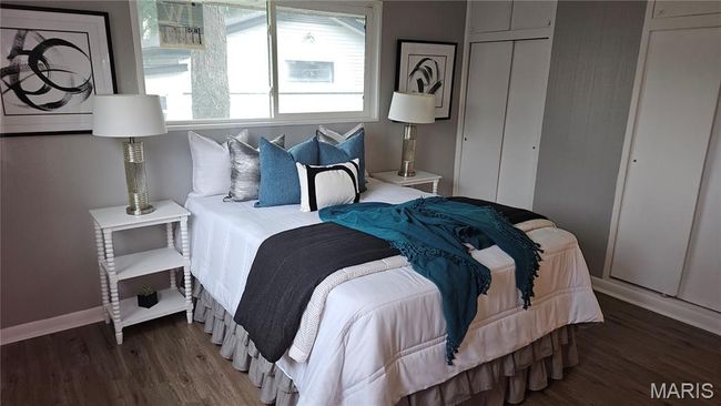 Bedroom with wood finished floors and a closet | Image 10