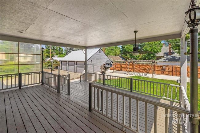Wooden deck featuring an outbuilding and a playground | Image 23