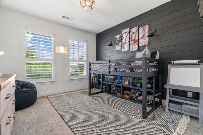 Carpeted bedroom featuring baseboards and wooden walls | Image 27