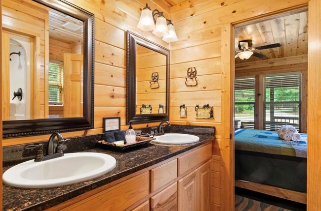 Ensuite bathroom featuring wooden walls, double vanity, and ceiling fan | Image 24