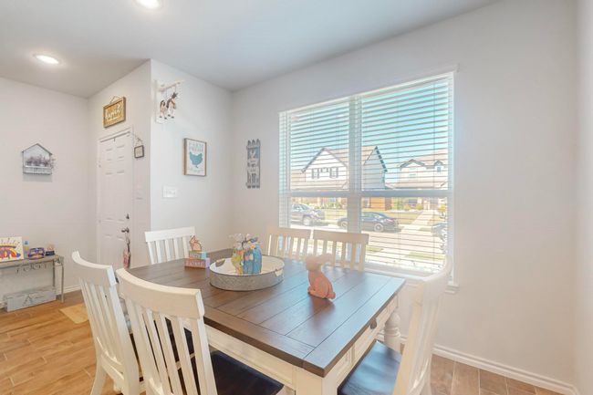 Dining area with light wood-style flooring, baseboards, and recessed lighting | Image 6