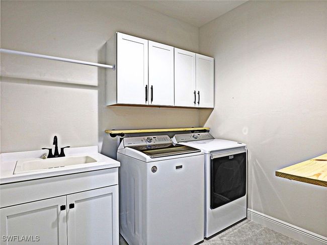 Laundry room with independent washer and dryer, cabinet space, and baseboards | Image 27