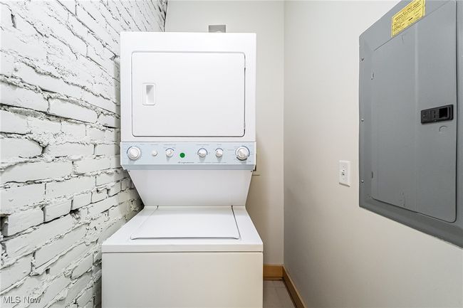 Laundry room with stacked washer / dryer and electric panel | Image 33