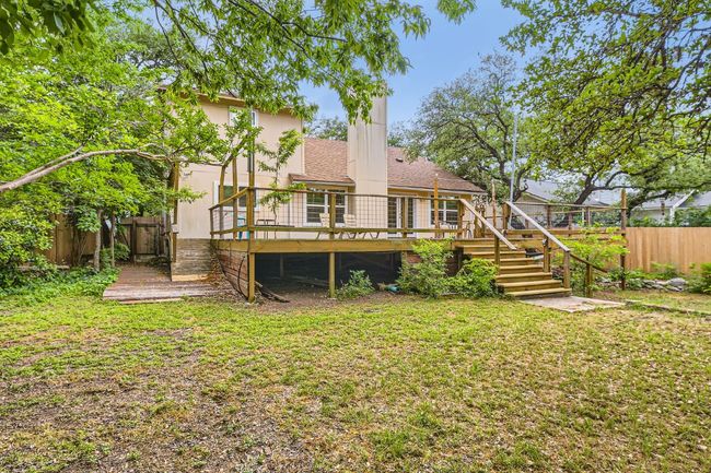 Back of house with stairs, a fenced backyard, a wooden deck, and a yard | Image 24