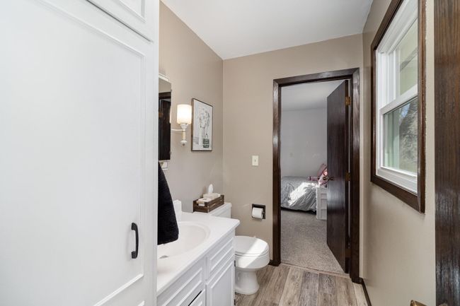 Conveniently located off the kitchen and one of the bedrooms, a handy half bath adds extra functionality and ease of access. | Image 12