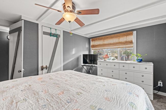 Carpeted bedroom with ceiling fan | Image 22