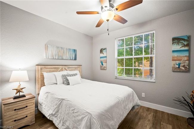 Bedroom featuring a ceiling fan, baseboards, and wood finished floors | Image 13