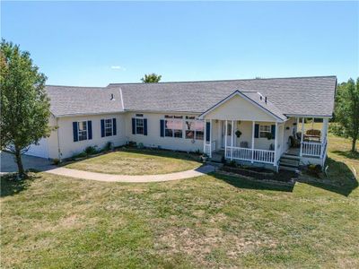 Ranch-style home featuring a porch and a front lawn | Image 2