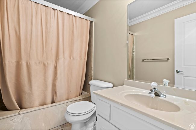 Full bathroom featuring ornamental molding, vanity, and shower / bath combo with shower curtain | Image 24
