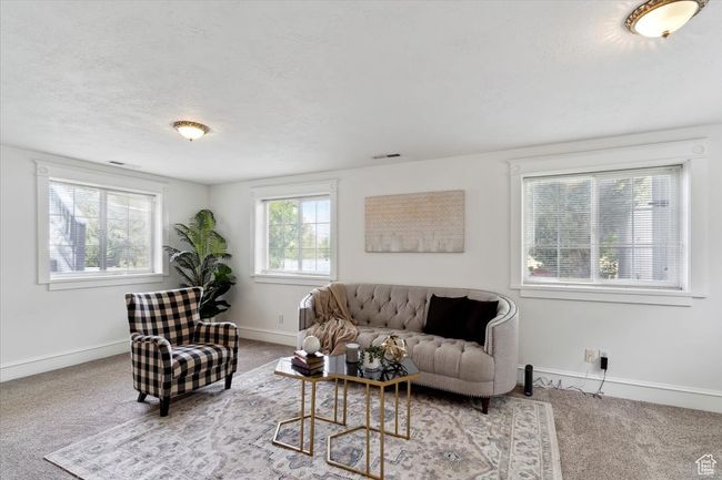 Living room with carpet, baseboards, and a textured ceiling | Image 21