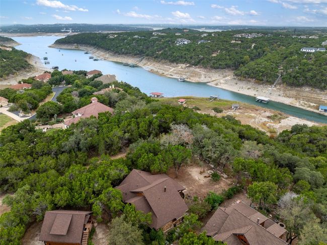 Expansive view from above showing the home, garage, fire pit and Devils Cove in the distance. | Image 35