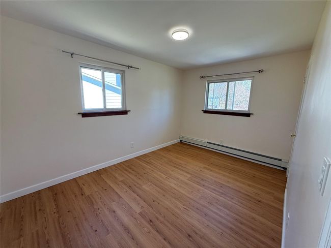 Spare room featuring baseboards, wood finished floors, and a baseboard radiator | Image 10