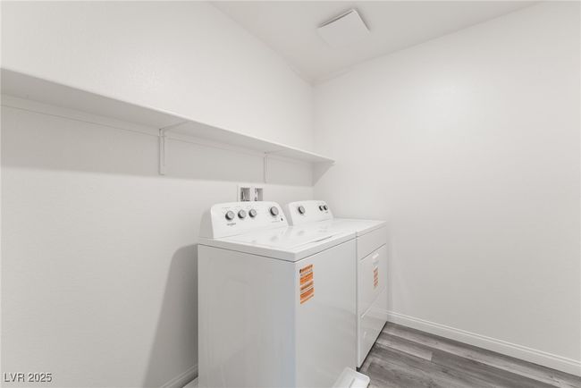 Laundry area with washing machine and clothes dryer and light wood finished floors | Image 32
