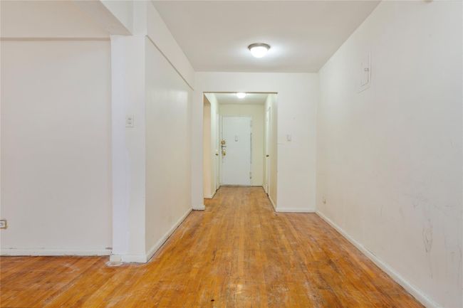 Corridor featuring light wood-type flooring and baseboards | Image 8