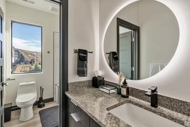 Bathroom with toilet, visible vents, wood finished floors, and vanity | Image 46