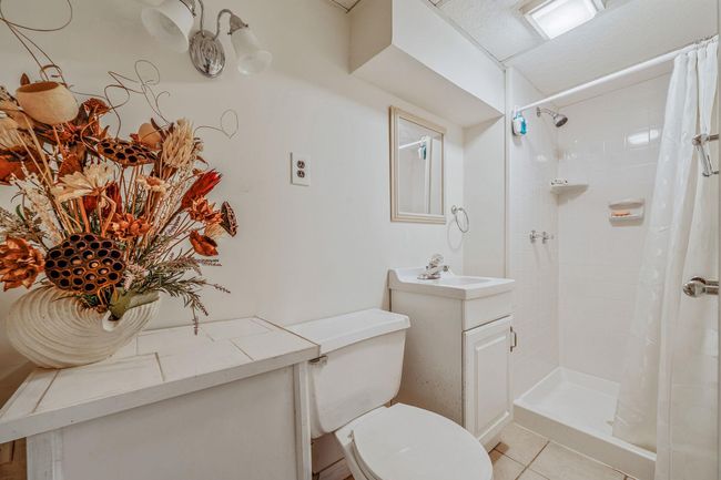 Bathroom with vanity, a tile shower, and tile patterned floors | Image 22