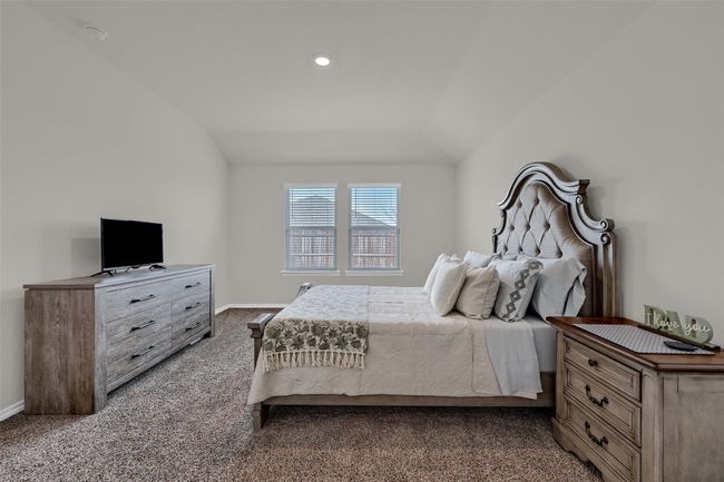 Bedroom featuring carpet and lofted ceiling | Image 19
