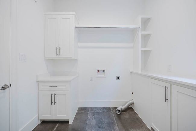Laundry room featuring hookup for a washing machine, hookup for an electric dryer, and cabinet space | Image 22