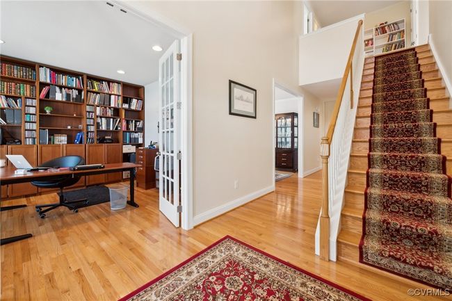Front entry of the home with 2 story foyer and chandelier. Foyer is very wide and inviting. Encased opening leads to formal dining room. | Image 26