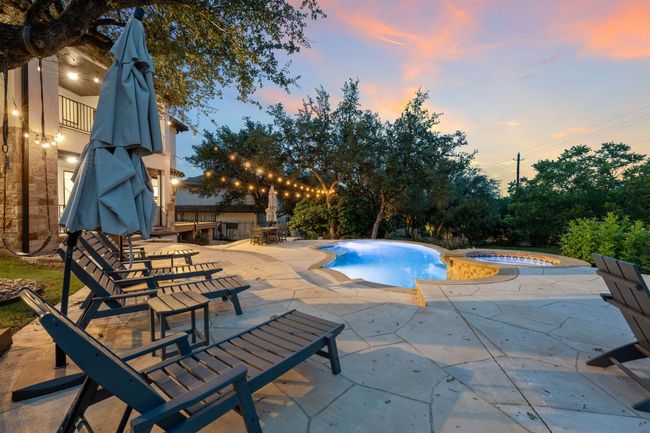 View of pool featuring a patio and a pool with connected hot tub | Image 5