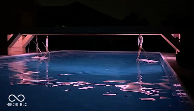 Lights under the walkway that has two swings for relaxing. | Image 33