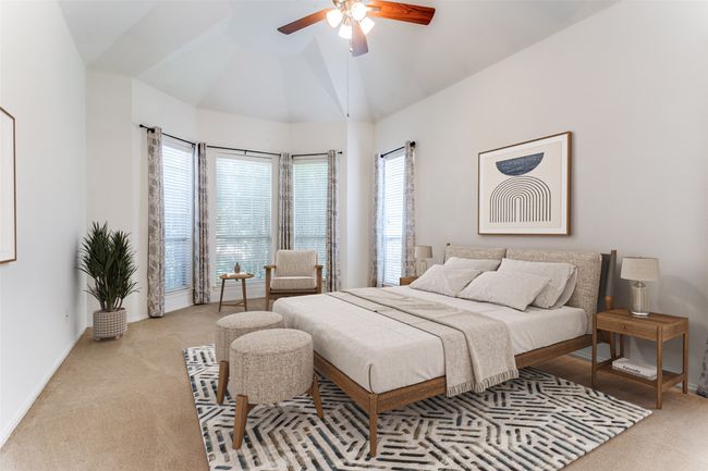 Bedroom featuring carpet flooring, baseboards, ceiling fan, and high vaulted ceiling | Image 28