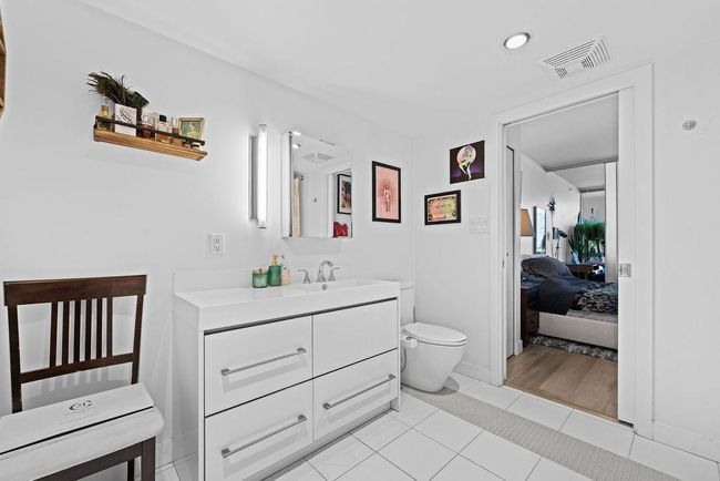 Ensuite bathroom featuring visible vents, toilet, connected bathroom, vanity, and tile patterned floors | Image 16