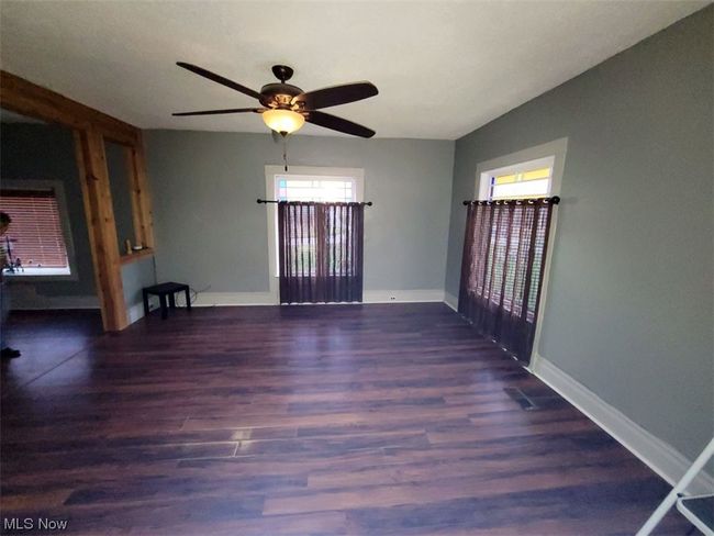 Spare room with dark wood-type flooring and ceiling fan | Image 6