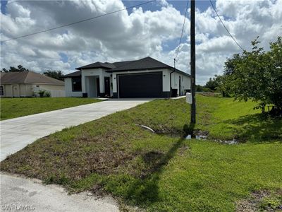 View of front facade featuring a garage and a front yard | Image 3