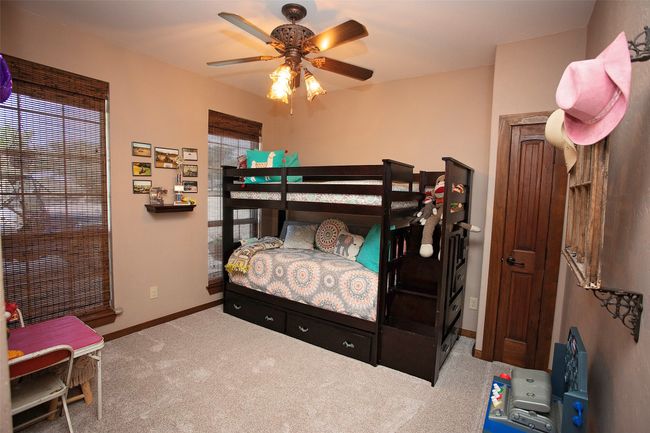 Carpeted bedroom with baseboards and a ceiling fan | Image 17