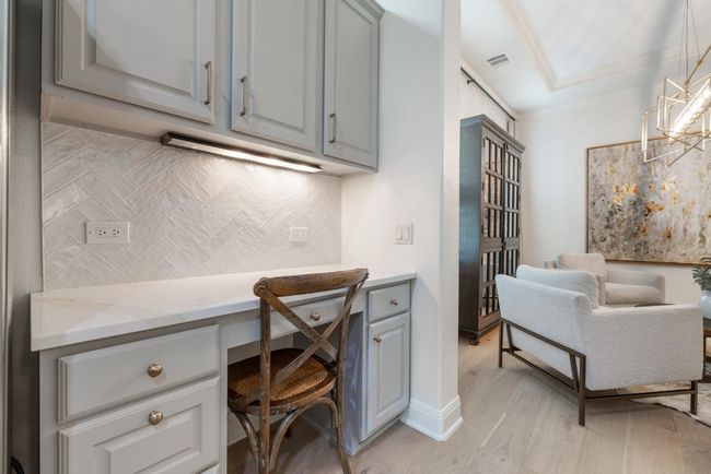 Office nook featuring built in desk and light wood finished floors | Image 11