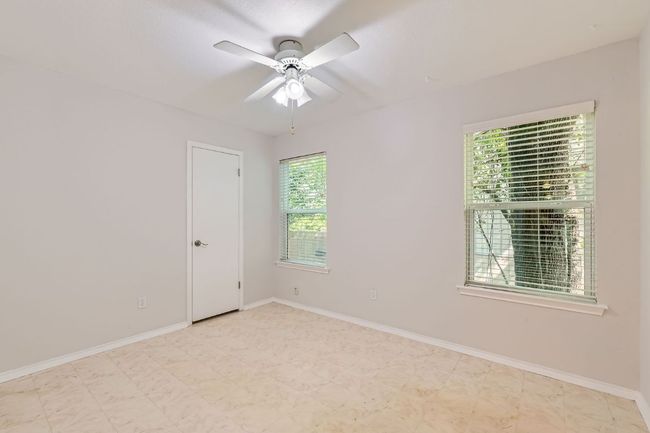 Spare room with baseboards, ceiling fan, and a wealth of natural light | Image 14