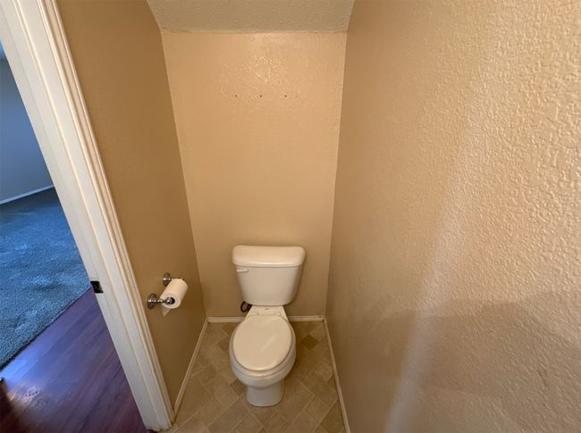 Bathroom with a textured ceiling and toilet | Image 10