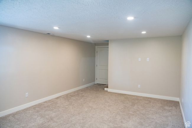 Spare room featuring light colored carpet, recessed lighting, and a textured ceiling | Image 26
