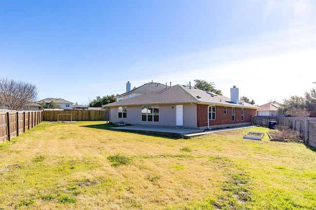 Back of property with a patio area, brick siding, a fenced backyard, and a chimney | Image 27