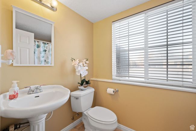 Bathroom featuring a healthy amount of sunlight, toilet, and sink | Image 31
