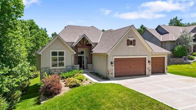 Craftsman-style home featuring a garage and a front yard | Image 3