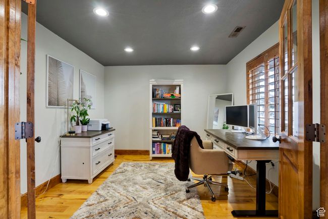 Office space featuring recessed lighting, baseboards, light wood-style floors, and visible vents | Image 13