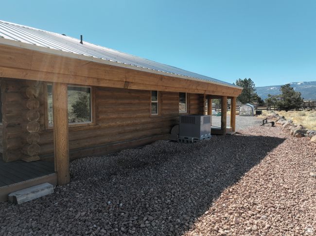 Exterior space with log siding, central air condition unit, metal roof, and a mountain view | Image 48